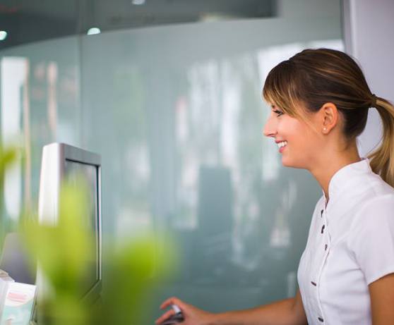 Dental team member sitting at computer