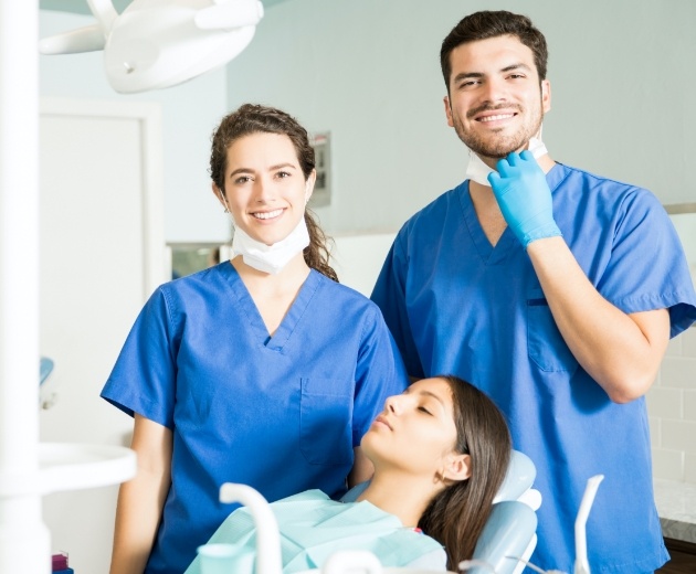 Two oral surgeons treating patient