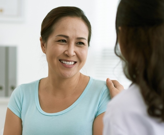 Woman smiling at oral surgeon