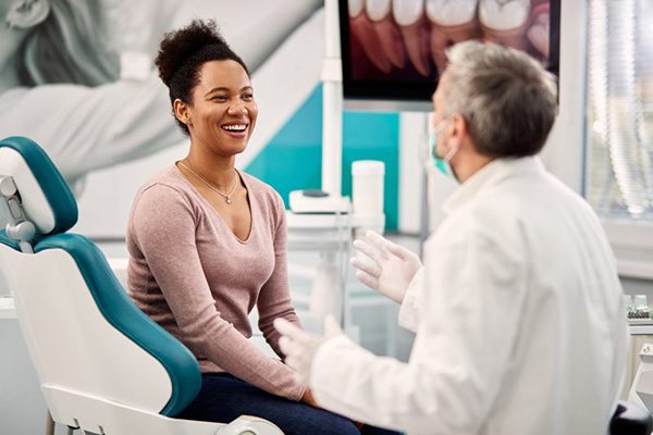 Dentist and patient happily consulting