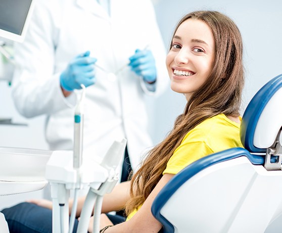 Female patient in dentist’s chair smiling