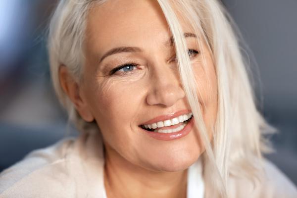 closeup of woman smiling after getting dental implants