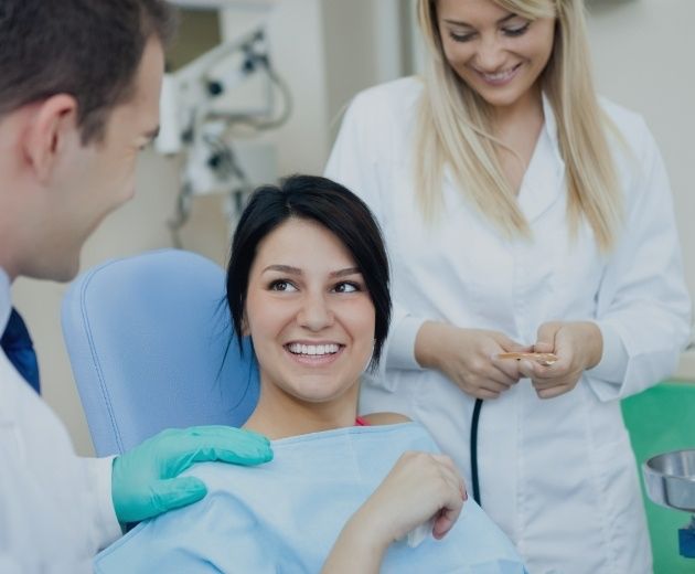 Young woman smiling while talking to her oral surgeon