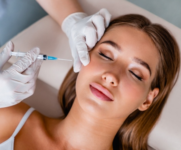 Woman receiving Botox injection from Burke oral surgeon