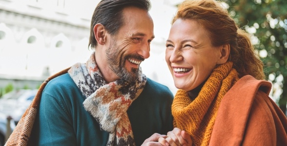 Man and woman laughing together outdoors